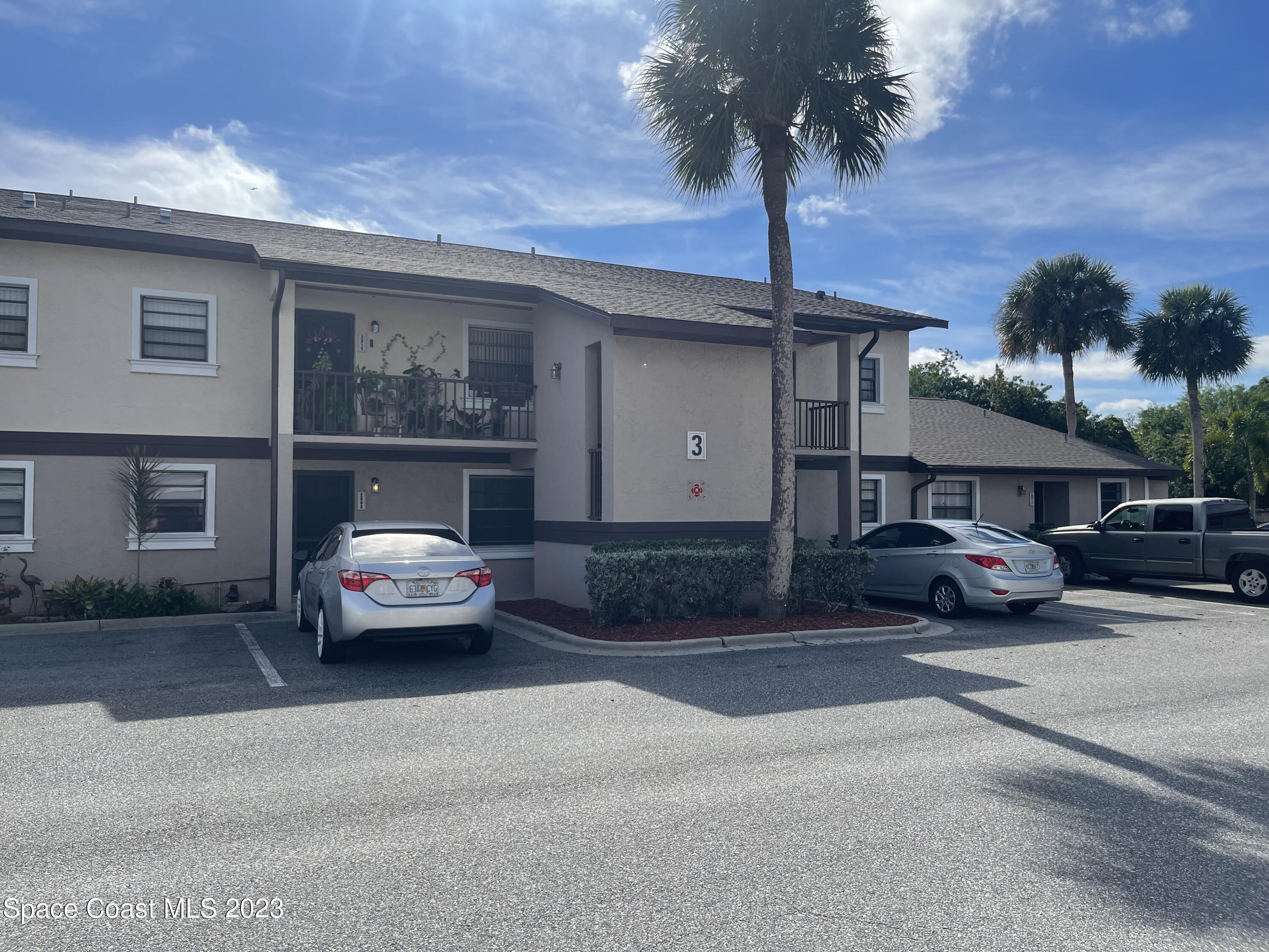a car parked in front of white house