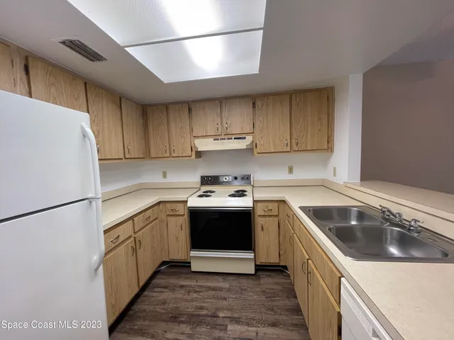 a kitchen with a sink and refrigerator