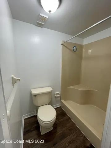 a bathroom with a toilet and a shower