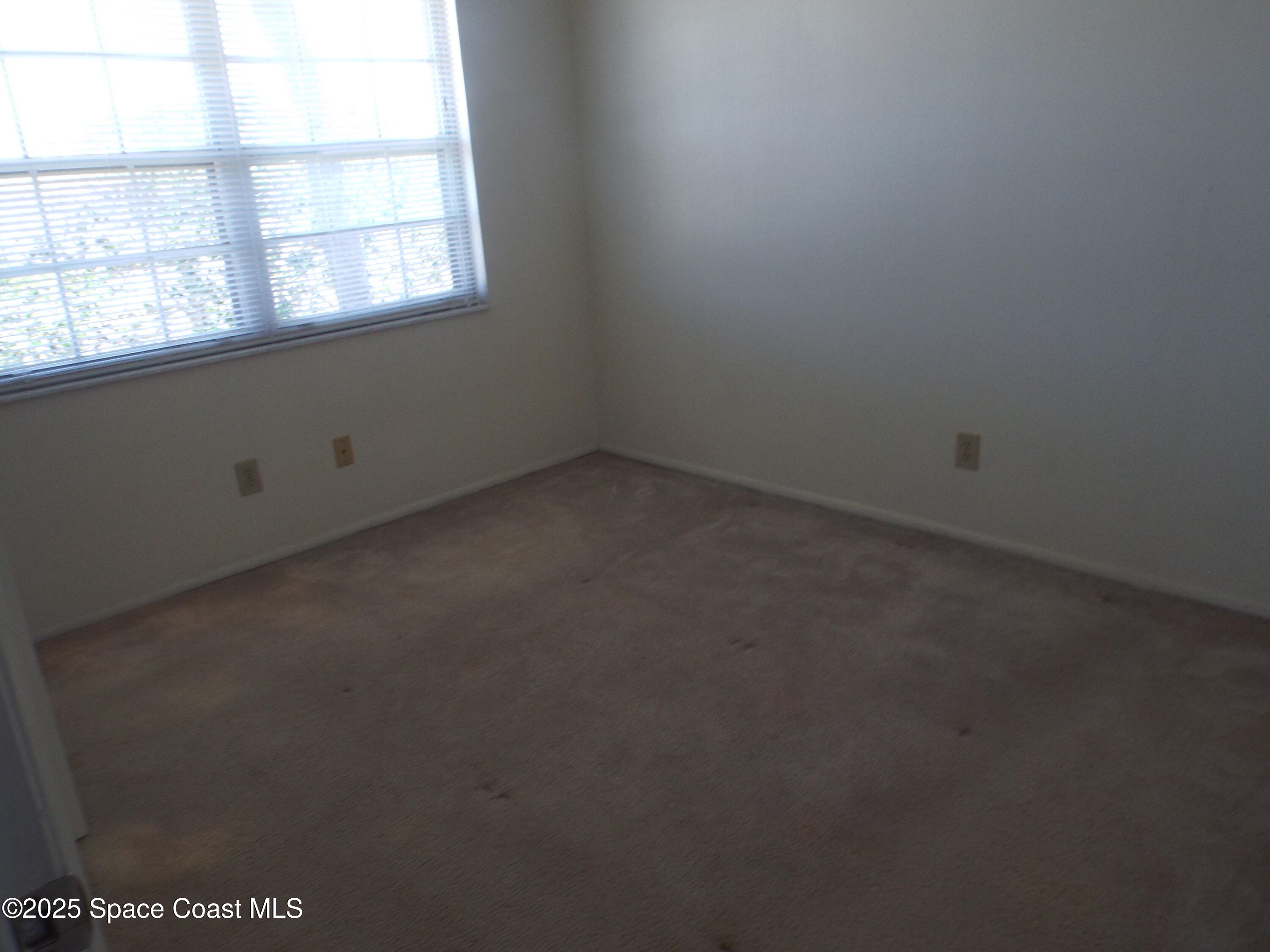 927 Sonesta Avenue Northeast, Unit 202 Palm Bay, FL 32905 - Photo 2 of 12 an empty room with a window
