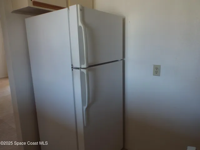 a view of a refrigerator in kitchen