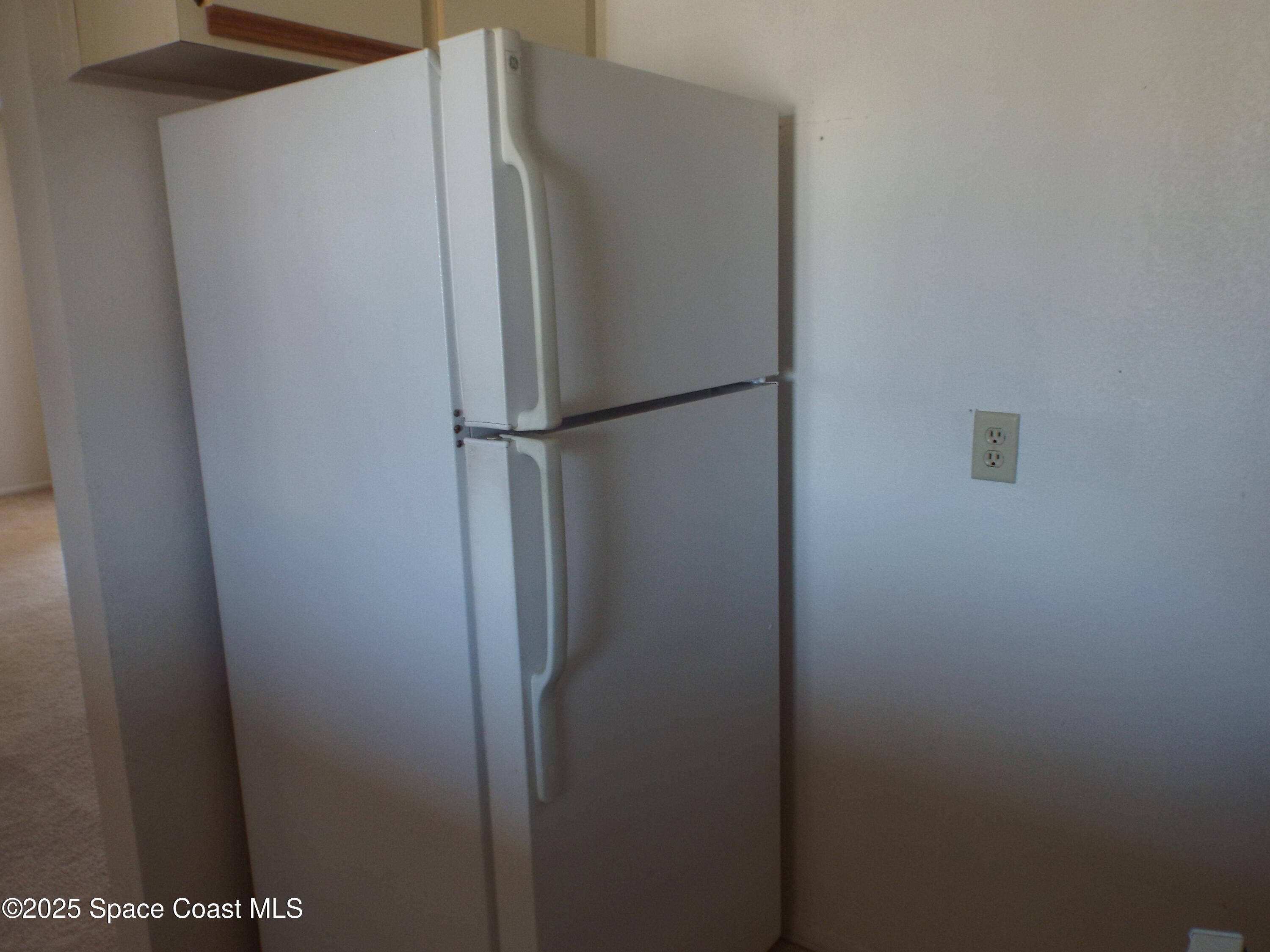 927 Sonesta Avenue Northeast, Unit 202 Palm Bay, FL 32905 - Photo 8 of 12 a view of a refrigerator in kitchen