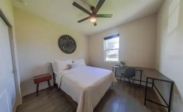 a bedroom with a bed and a window