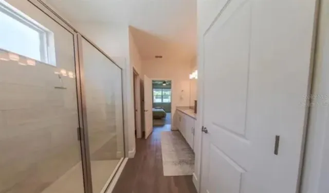 a view of a hallway with a wooden floor