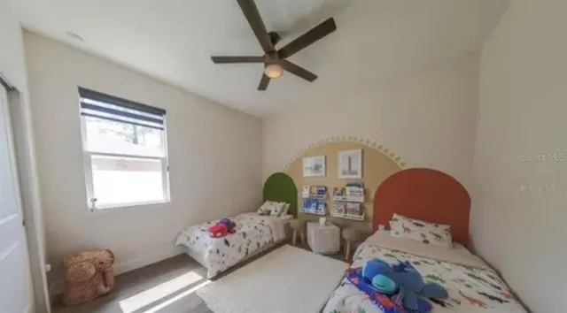 a bedroom with a bed and a window