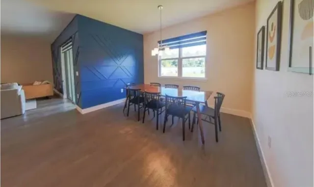 a view of a dining room with furniture and chandelier