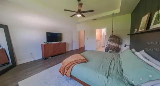 a bedroom with a bed and a television