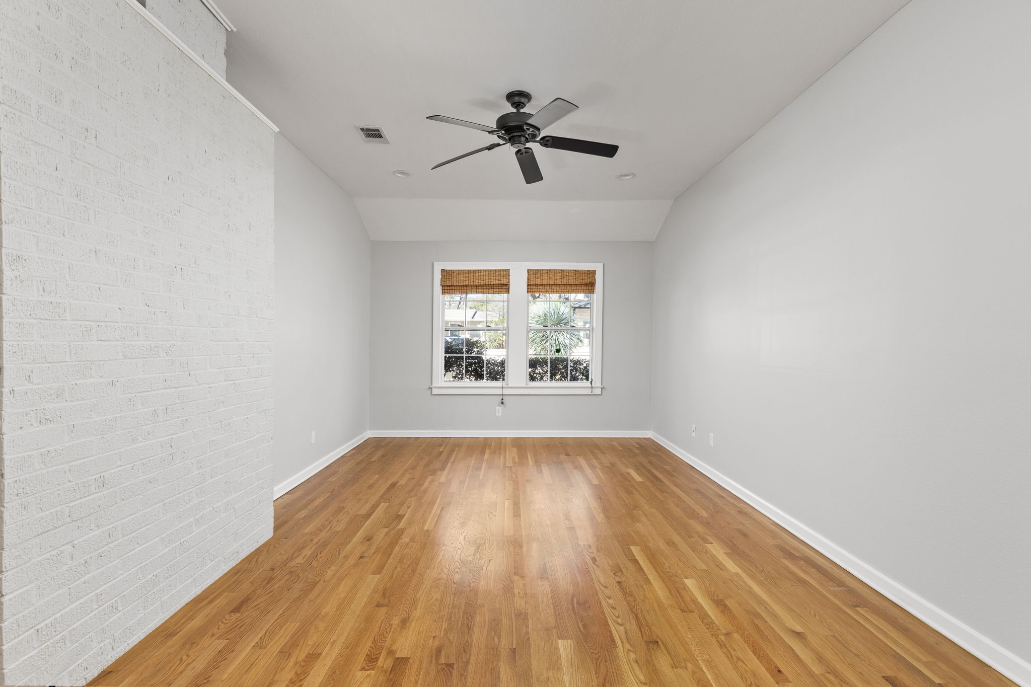 4517 Bull Creek Road Austin, TX 78731 - Photo 12 of 35 wooden floor in an empty room with a window