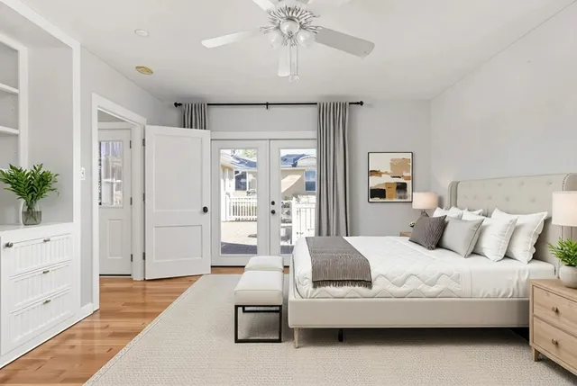 a bedroom with a large bed and a chandelier