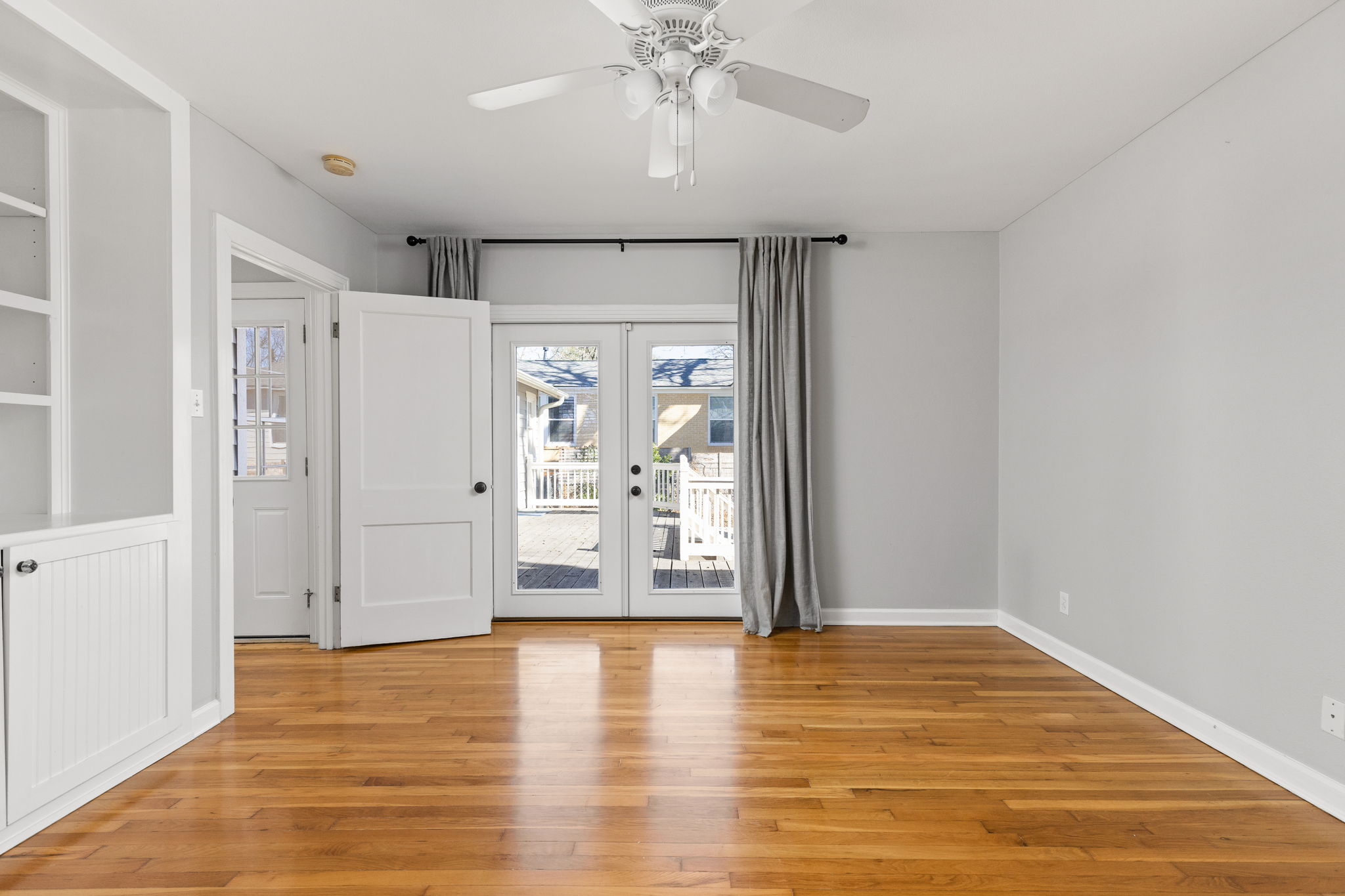 4517 Bull Creek Road Austin, TX 78731 - Photo 16 of 35 a view of an empty room with window and wooden floor