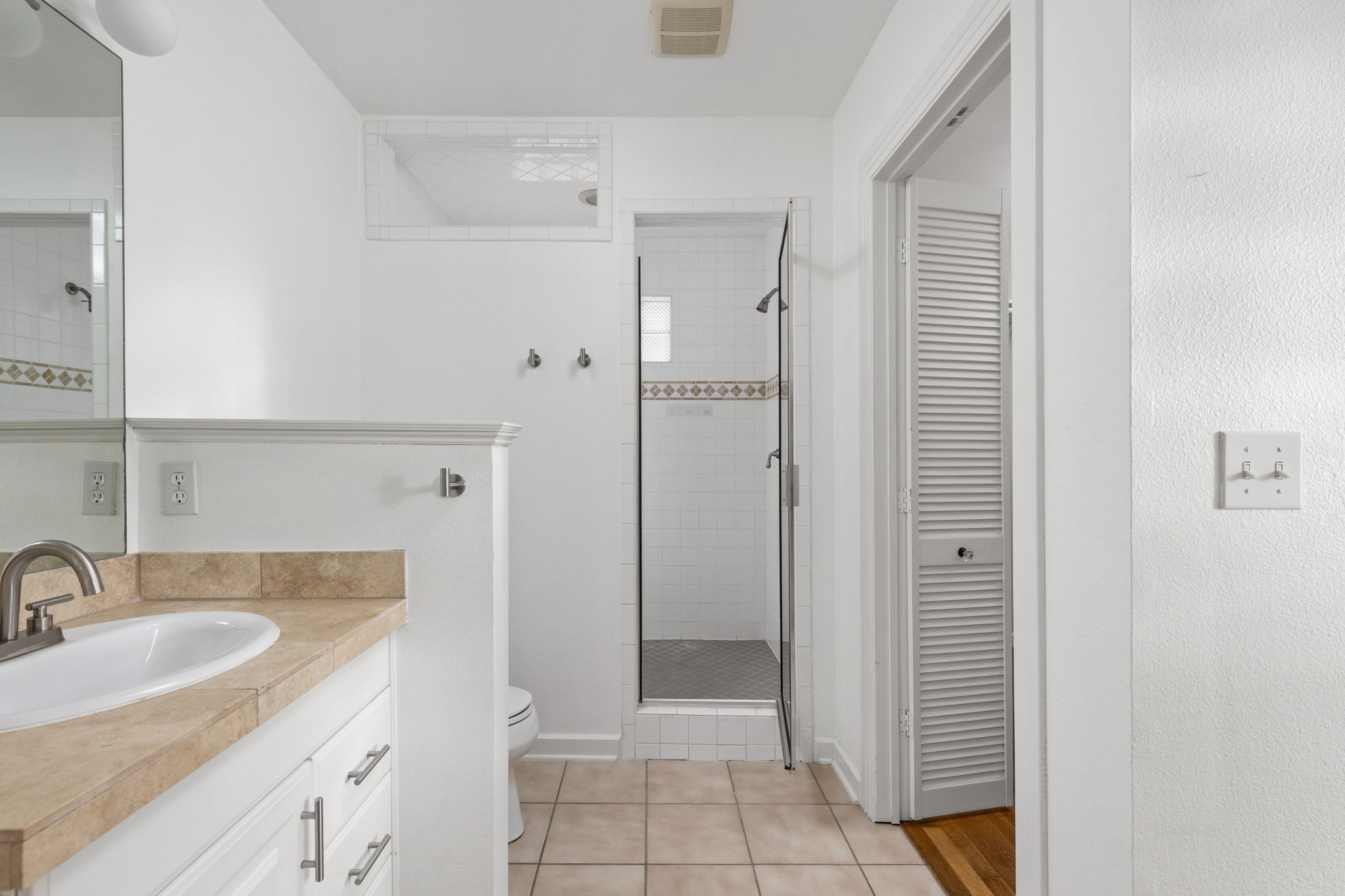 4517 Bull Creek Road Austin, TX 78731 - Photo 20 of 35 a bathroom with a sink and a mirror