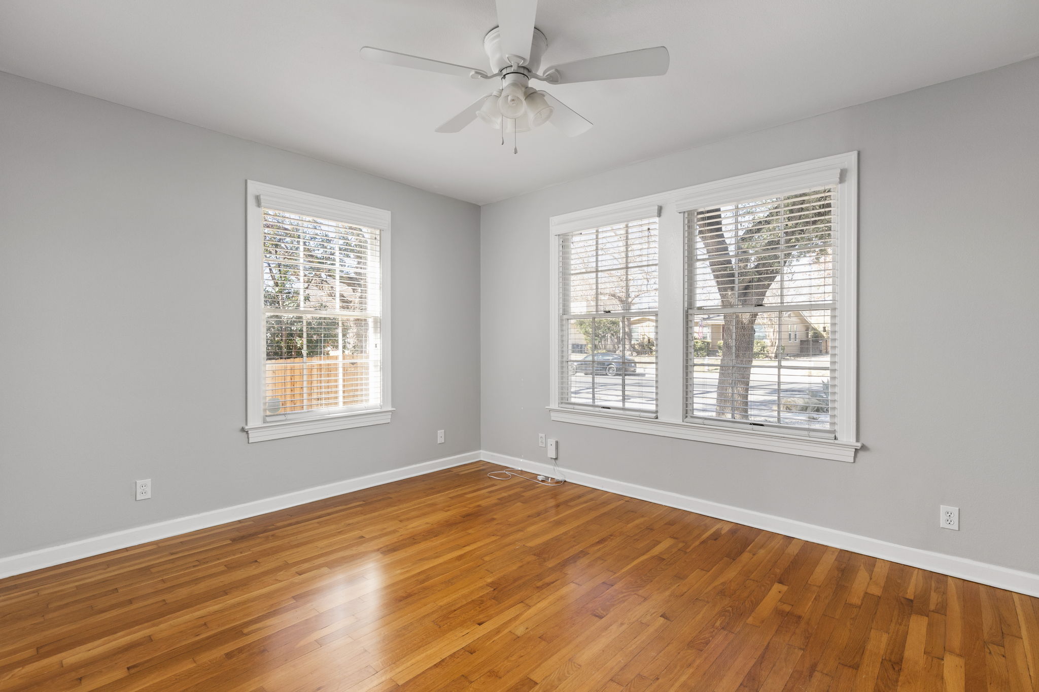 4517 Bull Creek Road Austin, TX 78731 - Photo 23 of 35 a view of an empty room with a window and wooden floor