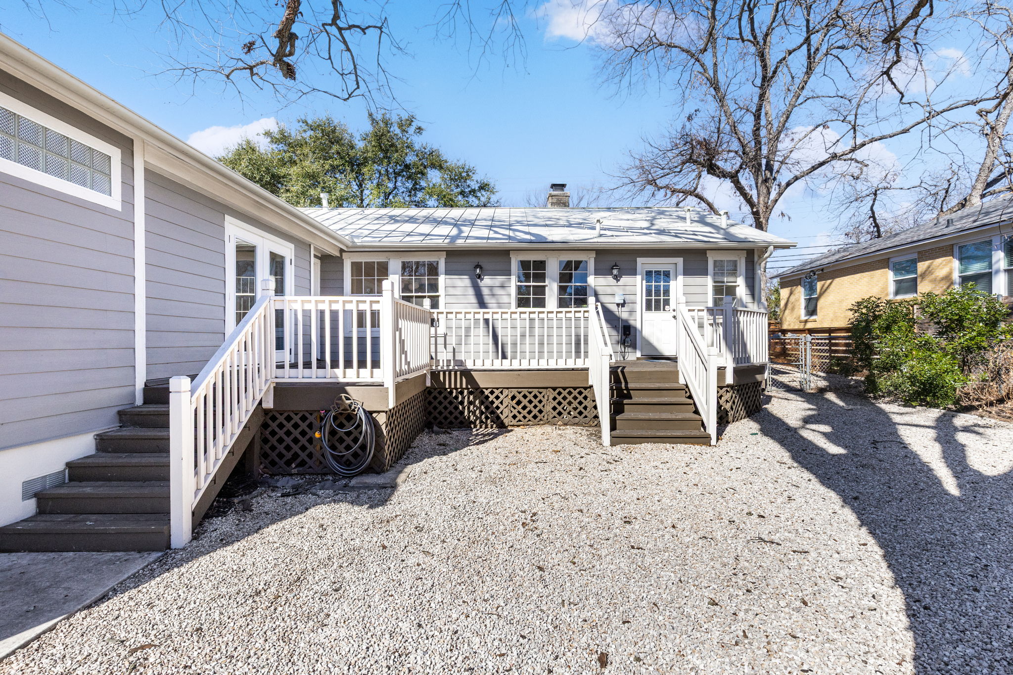 4517 Bull Creek Road Austin, TX 78731 - Photo 32 of 35 a view of a house with wooden deck and furniture