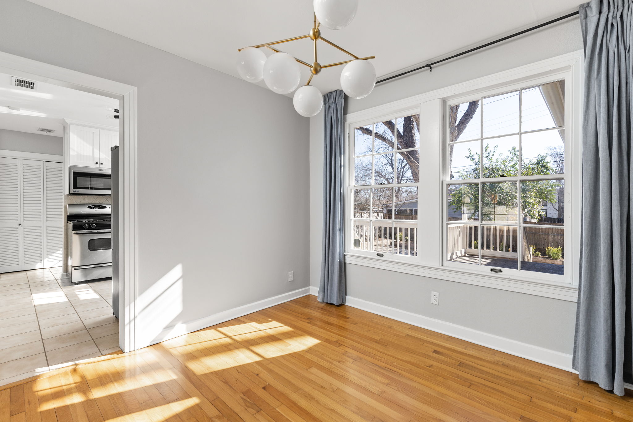 4517 Bull Creek Road Austin, TX 78731 - Photo 8 of 35 a view of empty room with wooden floor and fan