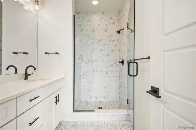 a bathroom with a shower sink and mirror