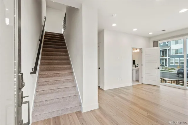 a view of a hallway with wooden floor and entryway
