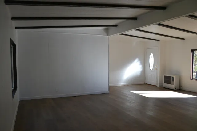 a room with a sink cabinets and a window