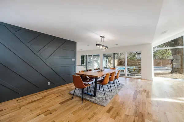 a dining room with furniture and wooden floor