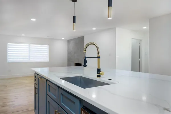 a kitchen with a sink and a refrigerator
