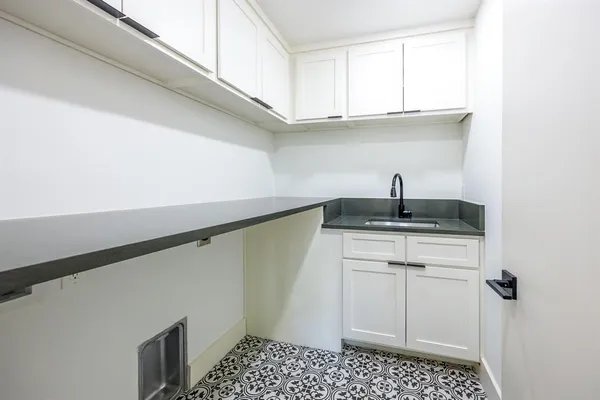 a kitchen with a sink and cabinets