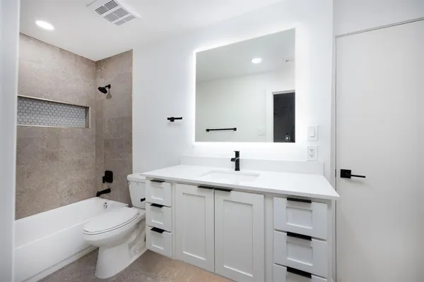 a bathroom with a shower and toilet