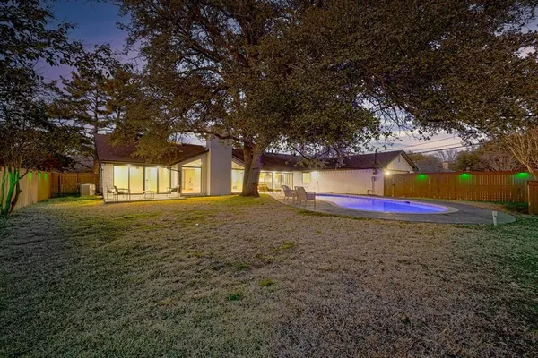 a view of a swimming pool with outdoor seating
