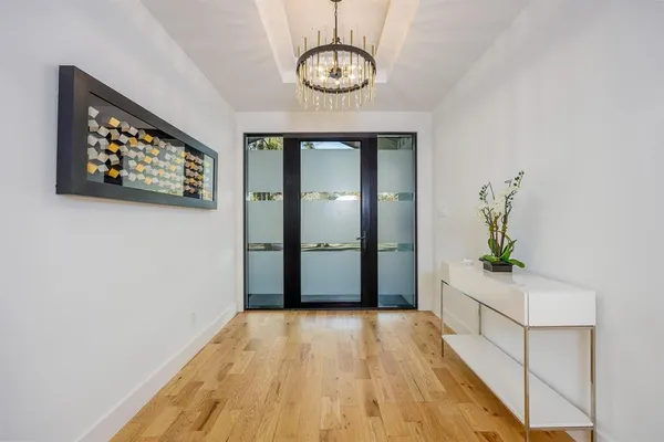 a view of an entryway with wooden floor