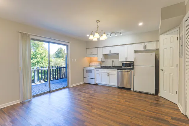 a kitchen with granite countertop stainless steel appliances a counter top space and cabinets