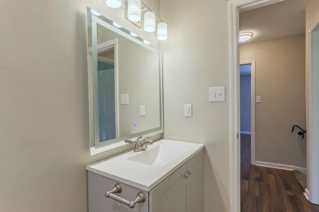 a bathroom with a sink a mirror and vanity