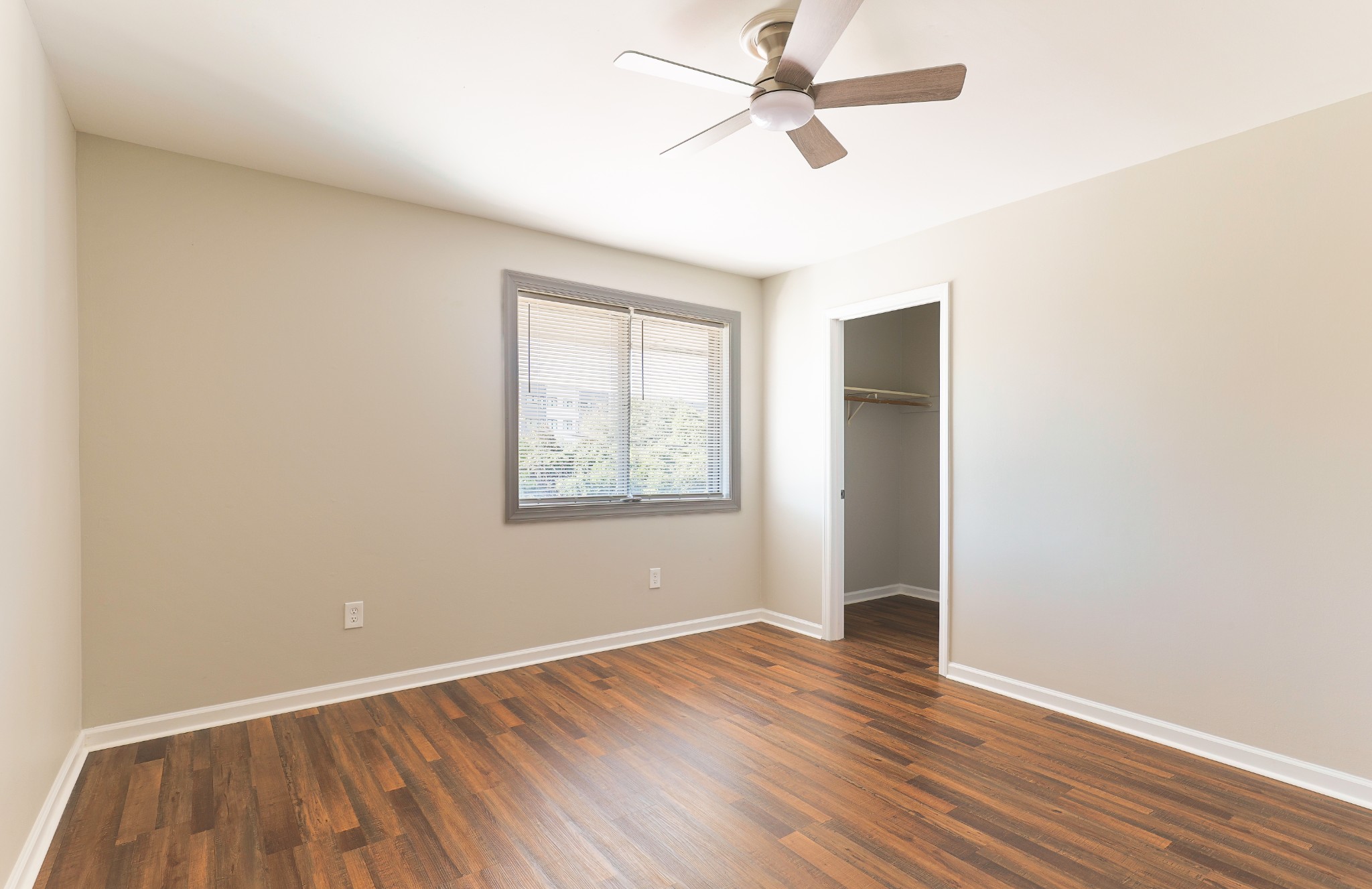 320 Welch Road, Unit L5 Nashville, TN 37211 - Photo 10 of 12 an empty room with wooden floor fan and windows