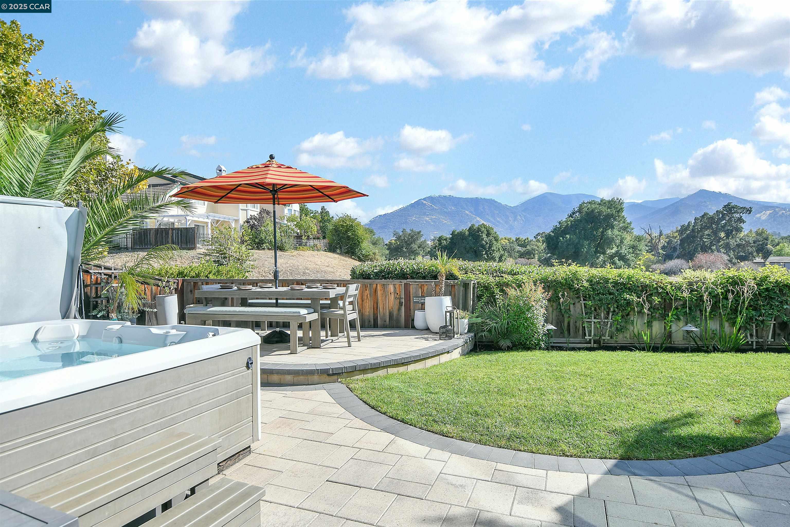a view of a swimming pool with lawn chairs under an umbrella