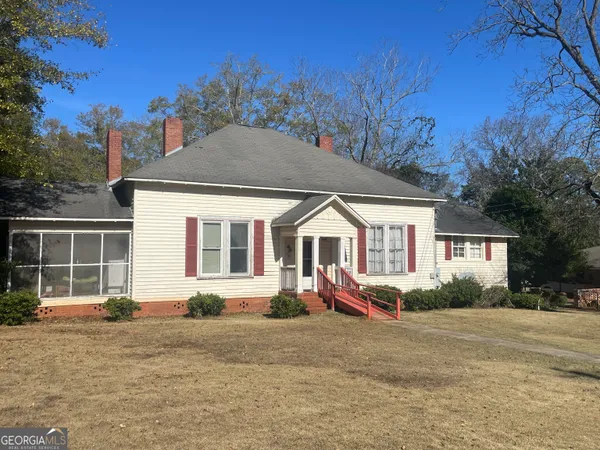 a front view of a house with a garden