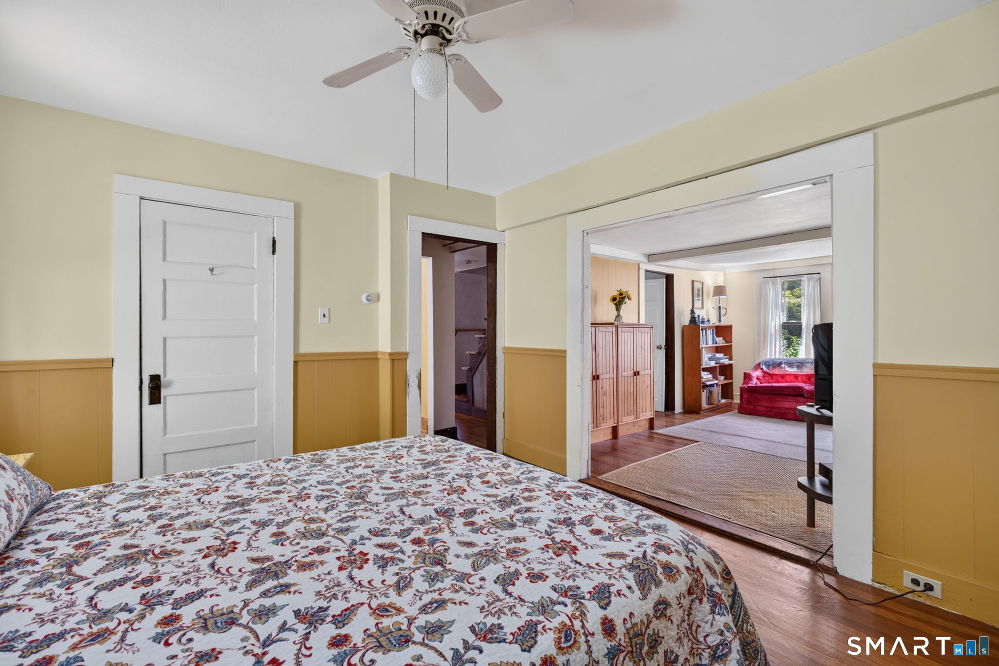 79 River Street Deep River, CT 06417 - Photo 12 of 40 a bedroom with a bed and a chandelier