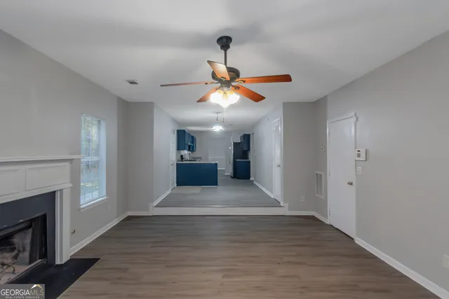 a view of water heater room with wooden floor