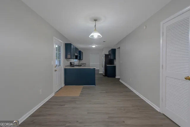 a view of a kitchen with a sink cabinets and wooden floor