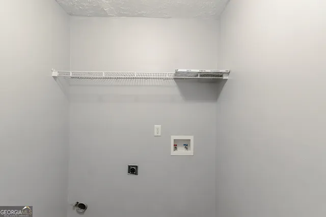 a close view of a utility room with dryer and washer