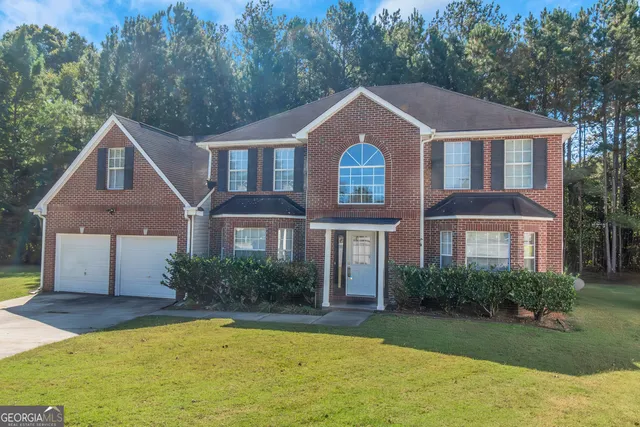 a aerial view of a house next to a yard