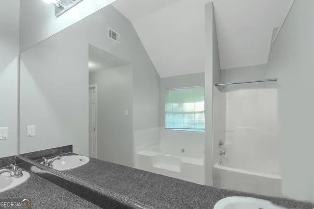 a bathroom with a bathtub and a sink