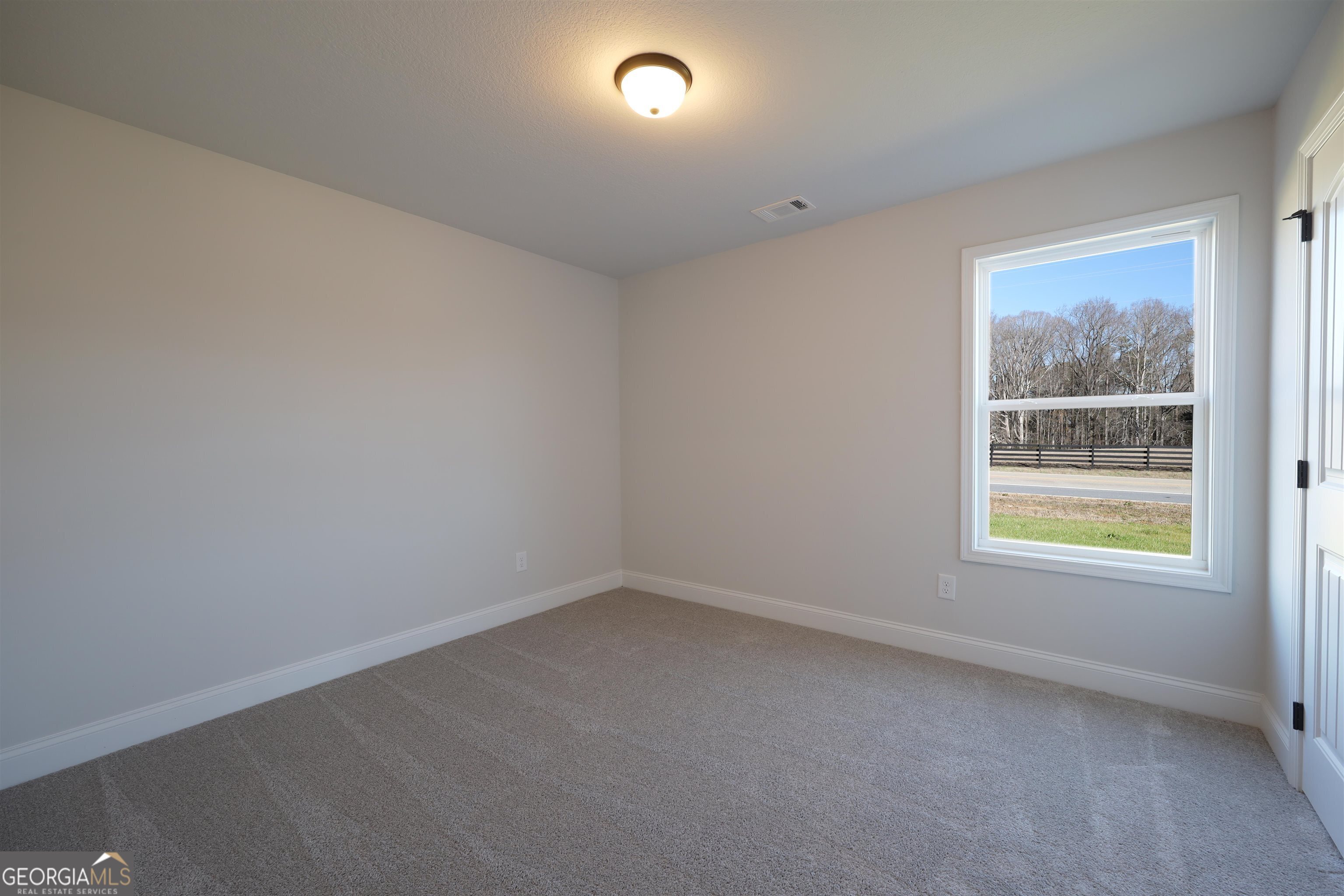 457 Tanners Bridge Circle, Unit 4 Bethlehem, GA 30620 - Photo 21 of 24 an empty room with windows