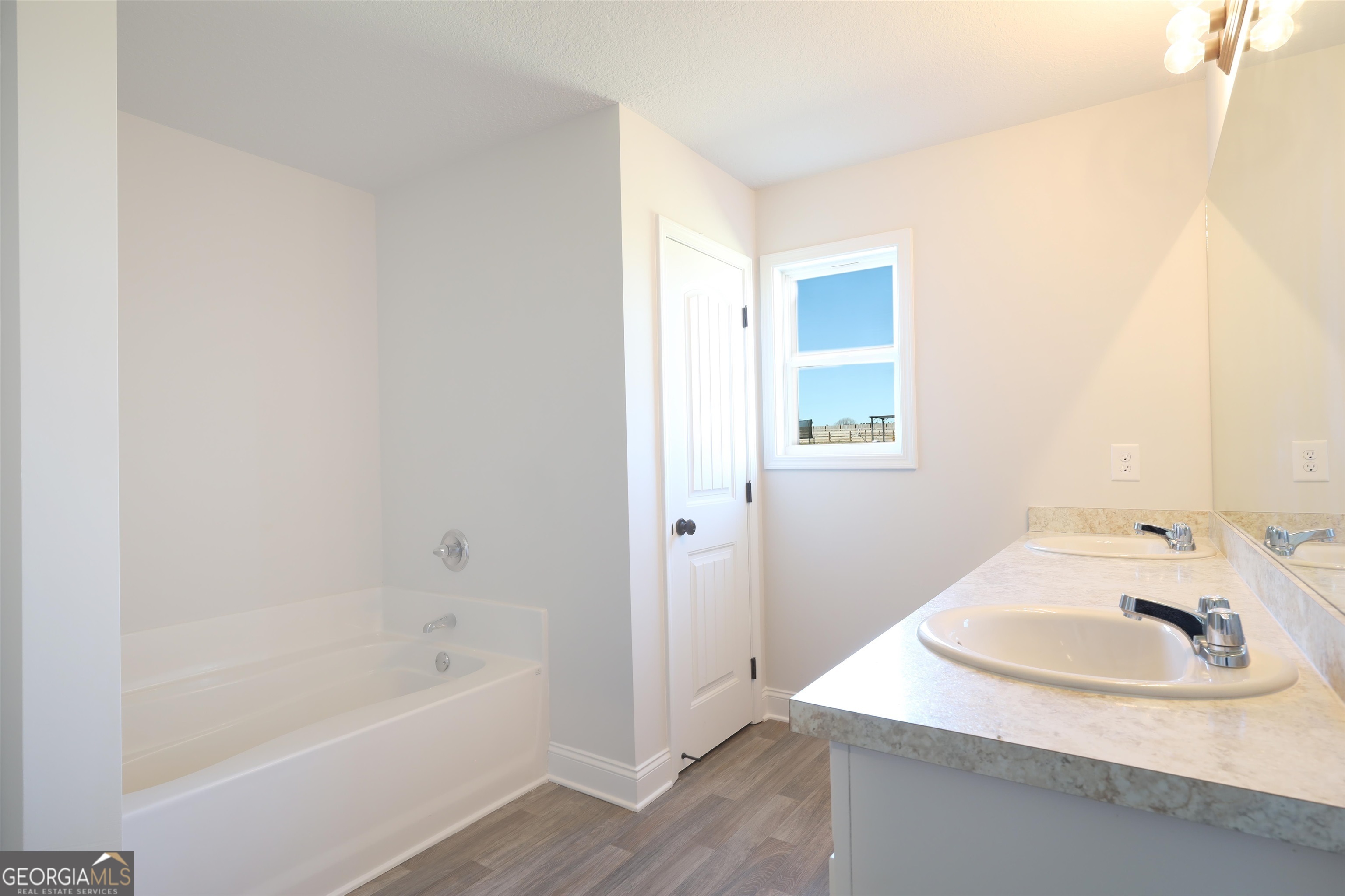 457 Tanners Bridge Circle, Unit 4 Bethlehem, GA 30620 - Photo 24 of 24 a bathroom with a sink and a bathtub