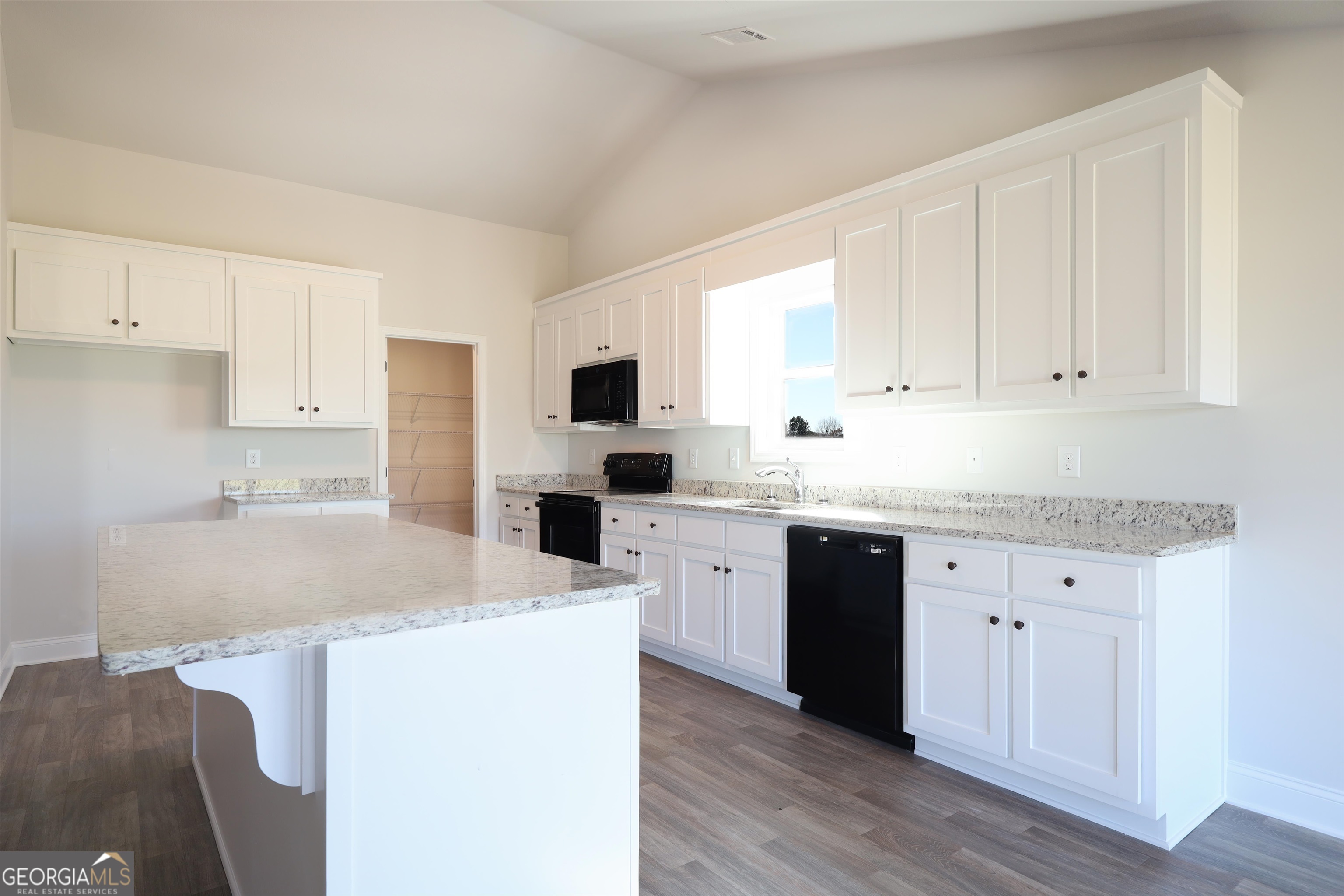 457 Tanners Bridge Circle, Unit 4 Bethlehem, GA 30620 - Photo 4 of 24 a kitchen with granite countertop white cabinets and white appliances
