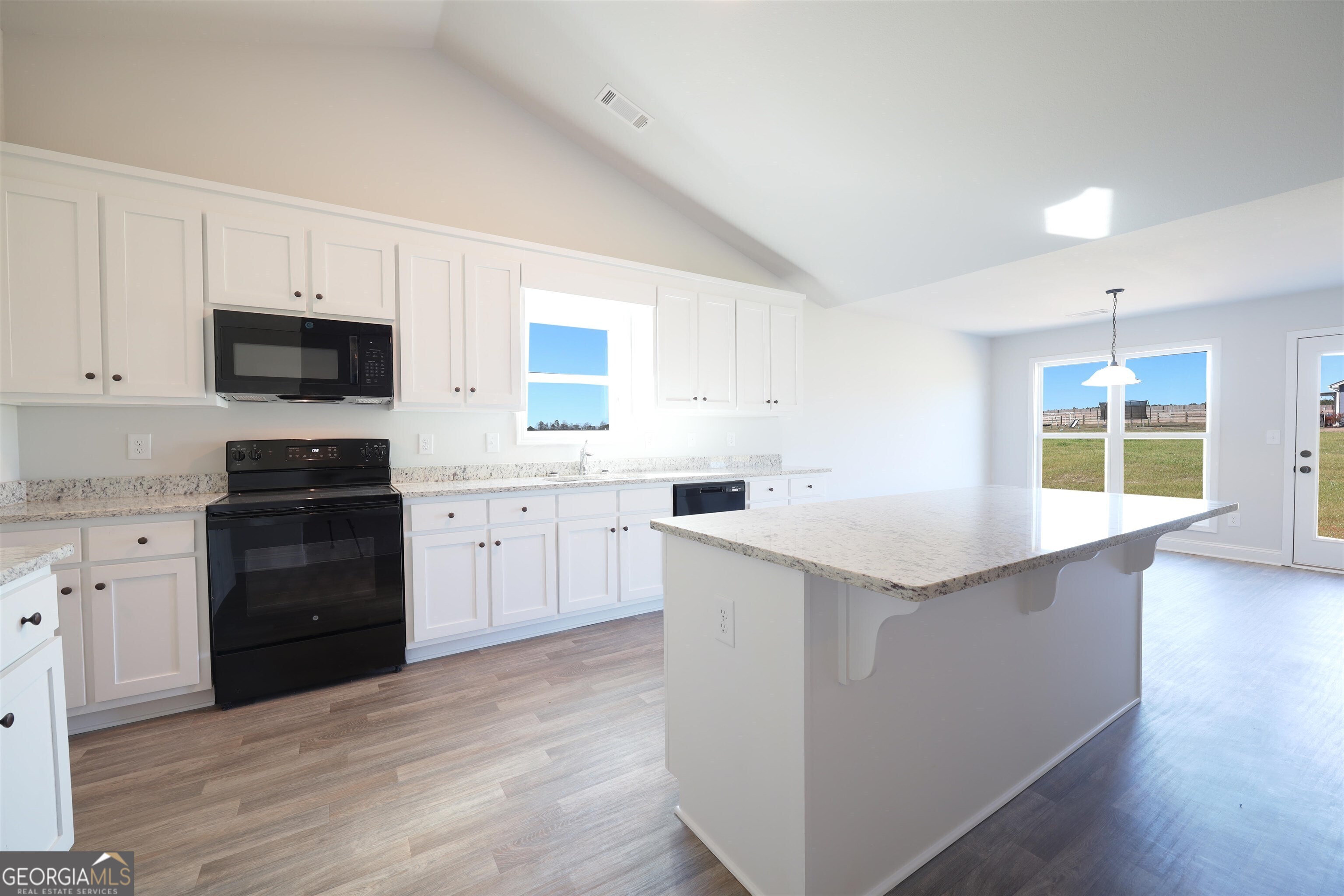 457 Tanners Bridge Circle, Unit 4 Bethlehem, GA 30620 - Photo 5 of 24 a kitchen with a sink stove and cabinets