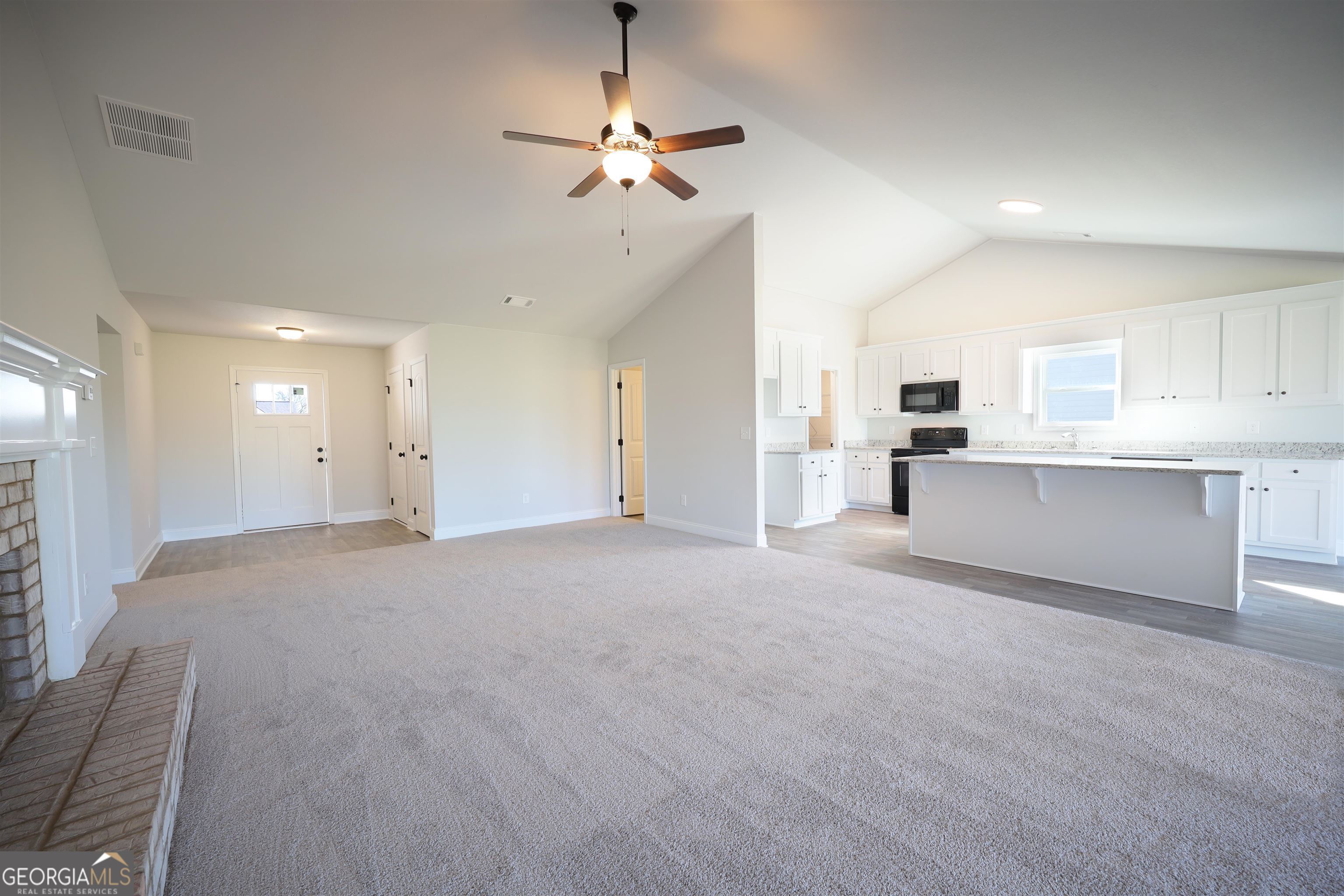 457 Tanners Bridge Circle, Unit 4 Bethlehem, GA 30620 - Photo 9 of 24 a view of a kitchen with furniture and a ceiling fan