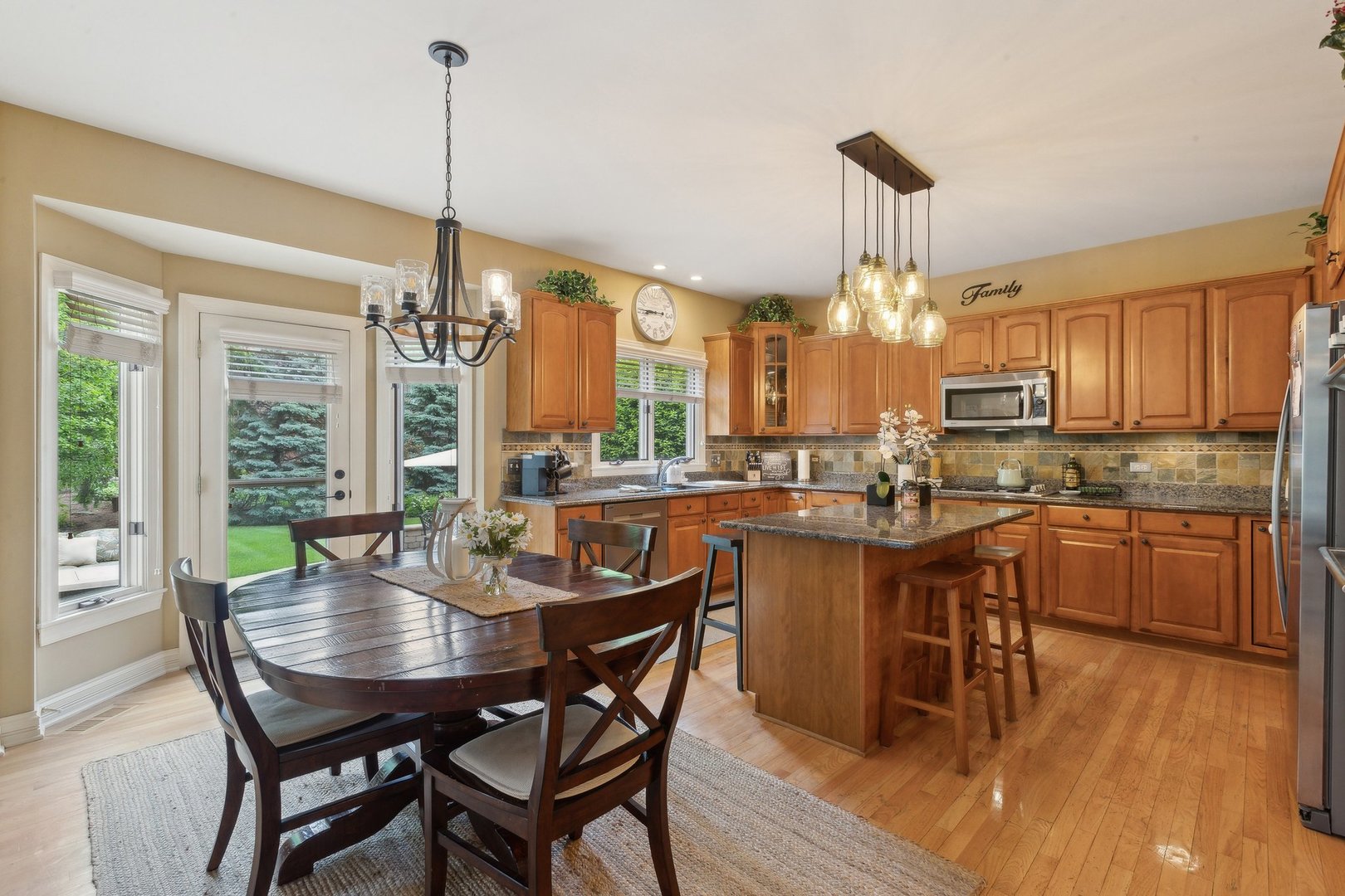 2156 Red Maple Lane Aurora, IL 60502 - Photo 21 of 57 a dining room filled chandelier and wooden floor