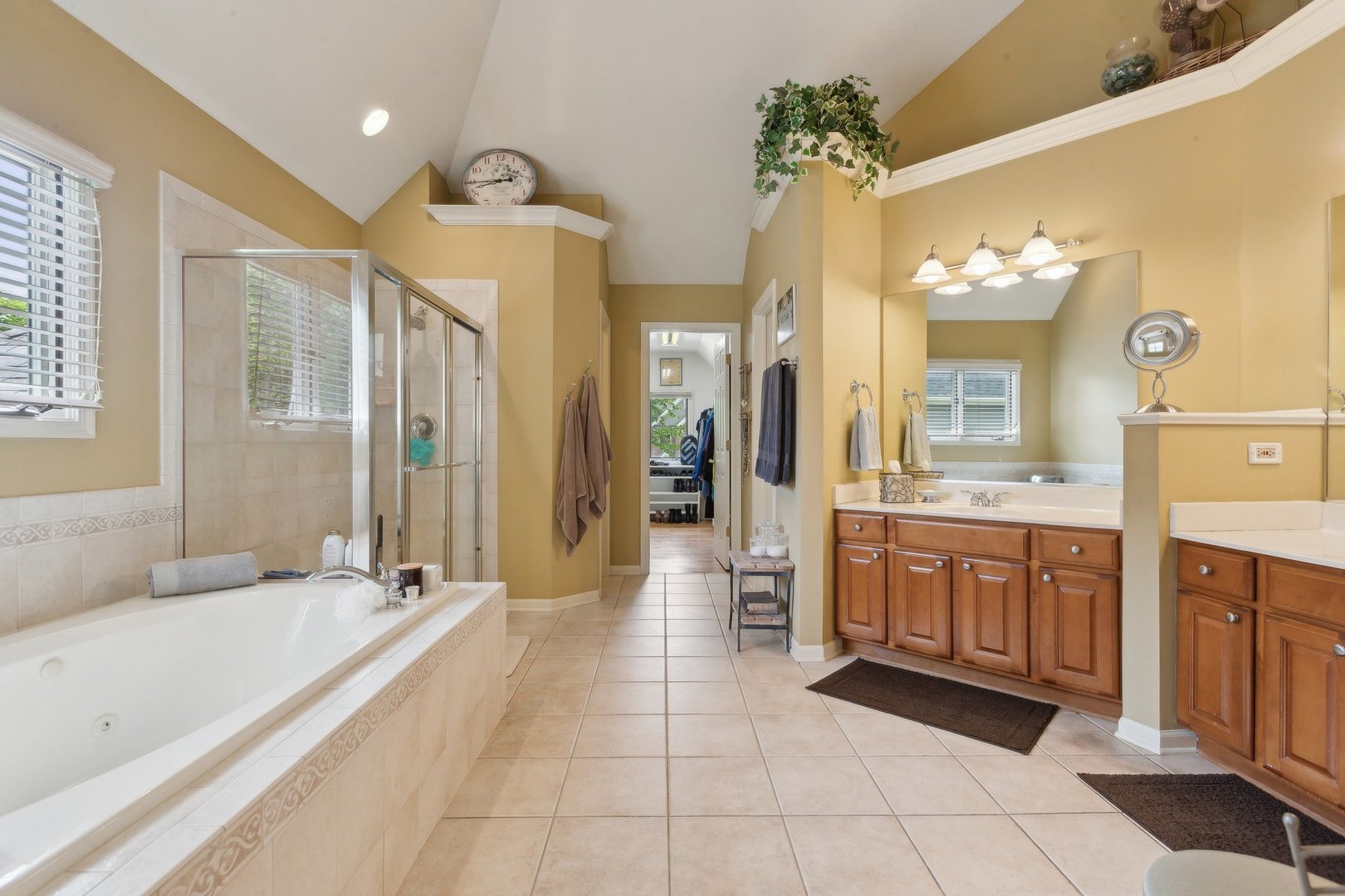2156 Red Maple Lane Aurora, IL 60502 - Photo 35 of 57 a spacious bathroom with a granite countertop sink a mirror a bathtub and a shower