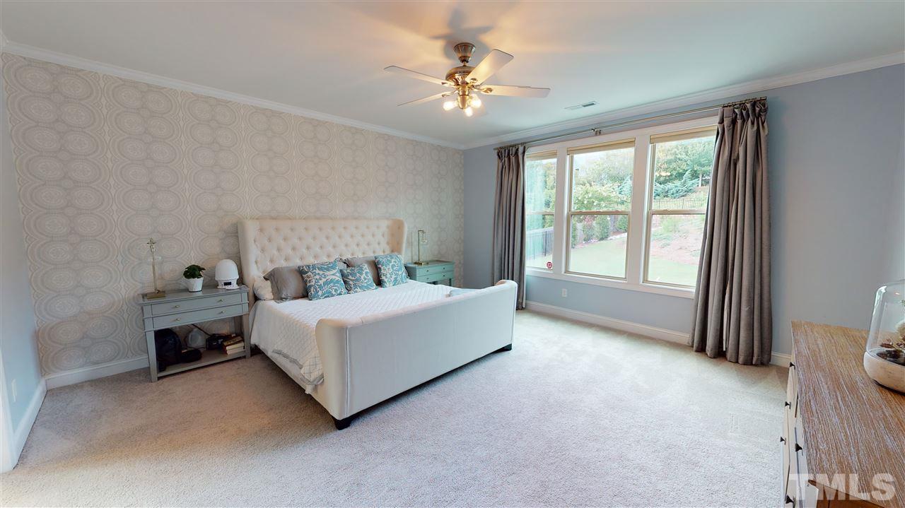 3116 Umstead View Drive Raleigh, NC 27607 - Photo 11 of 30 Elegantly styled master bedroom downstairs with relaxed view from the backyard!