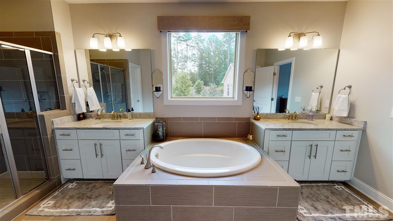 3116 Umstead View Drive Raleigh, NC 27607 - Photo 13 of 30 Owner's en suite bathroom features a garden tub with two separate vanities and a glass enclosed shower. Large walk in closet asl well in the suite!