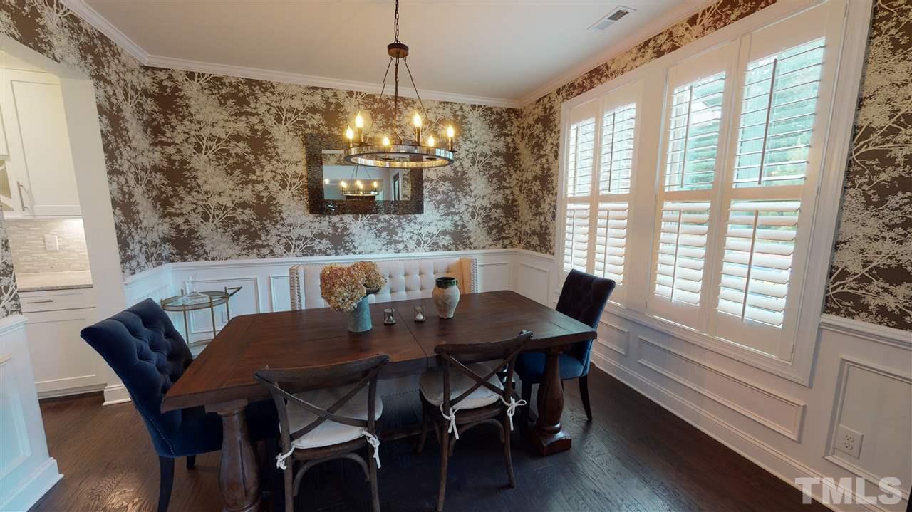3116 Umstead View Drive Raleigh, NC 27607 - Photo 3 of 30 Shutters, hardwoods, chandelier and steps to the butler's pantry make this dining room a dream for entertaining!