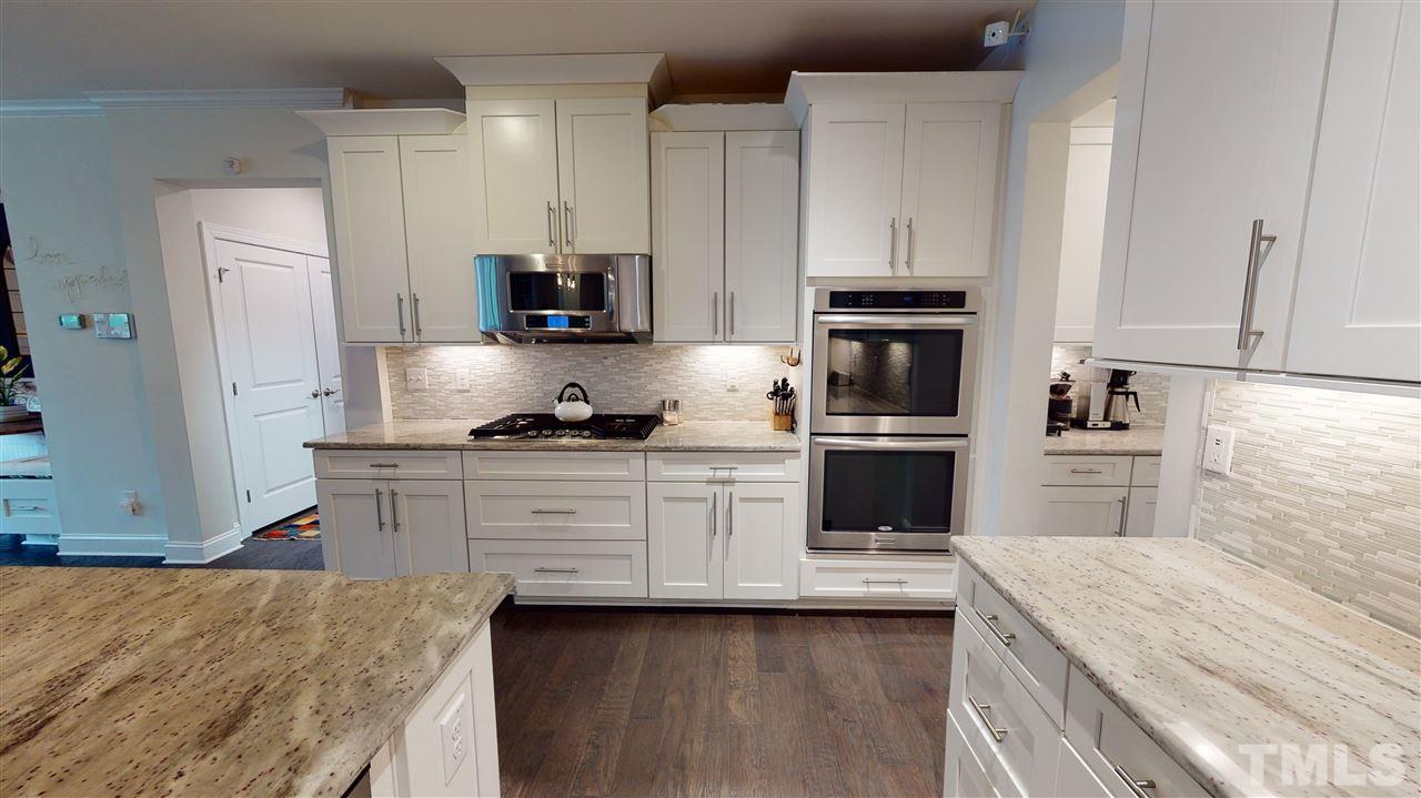 3116 Umstead View Drive Raleigh, NC 27607 - Photo 6 of 30 Turn the corner to this classic kitchen with stainless steel appliances, double oven, gas range and huge island for entertaining!