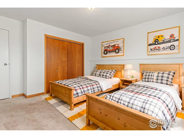 a bedroom with two beds and a window